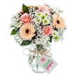 A beautifully composed bouquet, crafted by a talented Cricklewood florist, radiates warmth and romance as it sits gracefully in a clear glass vase upon a white canvas. The bouquet boasts lush, peach-blushed roses whose velvety petals spiral gently outward, each bloom glowing with the promise of heartfelt affection. Flanking these are two striking peach-orange gerberas featuring bold, chocolate centers, imbuing the arrangement with joyful energy. Dotted among these starring flowers are billowing tufts of airy white baby's breath, their cloud-like presence giving the composition a light, ethereal lift. White chrysanthemums with vibrant green centers nestle amid the assortment, offering refreshing notes that evoke memories of Sunday strolls along the Sidings Community Garden. Sparse yet vibrant eucalyptus leaves introduce rich shades of green and subtle texture, reinforcing the bouquet's organic grace. The blooms are artfully gathered in a vase with gently textured glass, through which stems and softly rippling water are clearly visible-a testament to the freshness Cricklewood is known for. The ensemble is finished with a rustic natural twine tied in a simple bow, from which a crisp white gift tag elegantly hangs-blank and waiting for a message of love, gratitude, or encouragement. Ideal for birthdays, milestones, or just because, this arrangement captures a spirit of local comfort and artistry unique to Cricklewood homes.